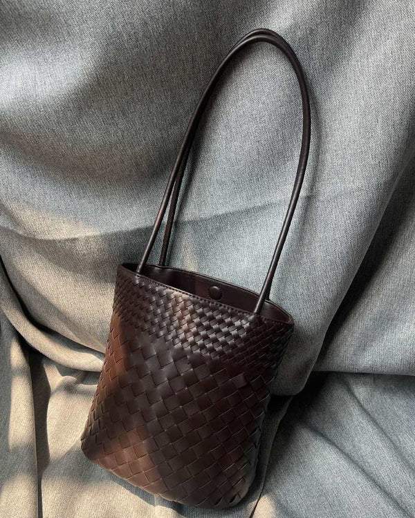 The Verona Woven Bucket in Black photographed at a three-quarter angle