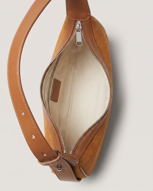 Cassis Crescent Bag lining — cream fabric lining with a leather tab