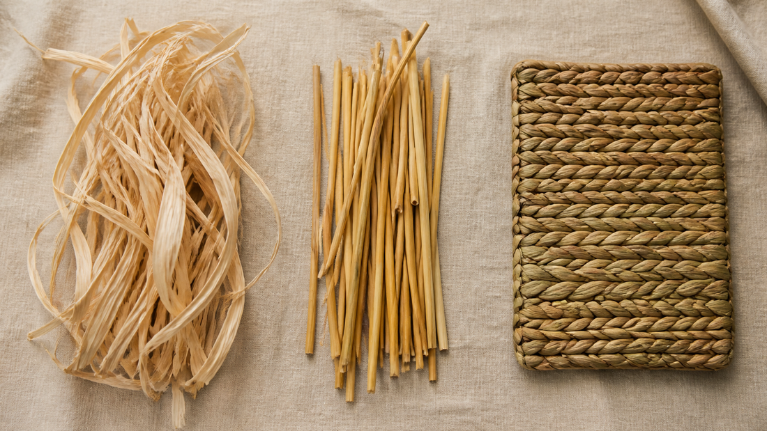Raffia strands, straw stalks and woven seagrass mat compared side by side on linen