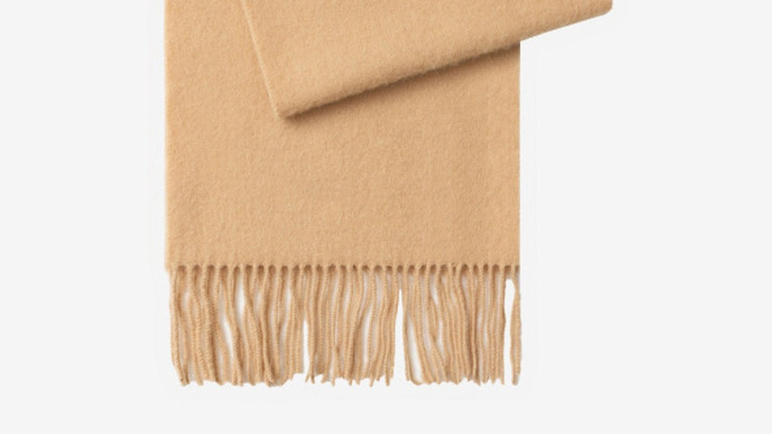 The Brushed Lambswool Long-Scarf in Camel, folded, showing the brushed surface and fringe.
