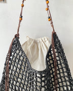 Wildfool Beaded Grass Tote in Black — three-quarter view, strap over shoulder