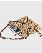 Wildfool Beaded Grass Tote in Black — three-quarter view, strap over shoulder