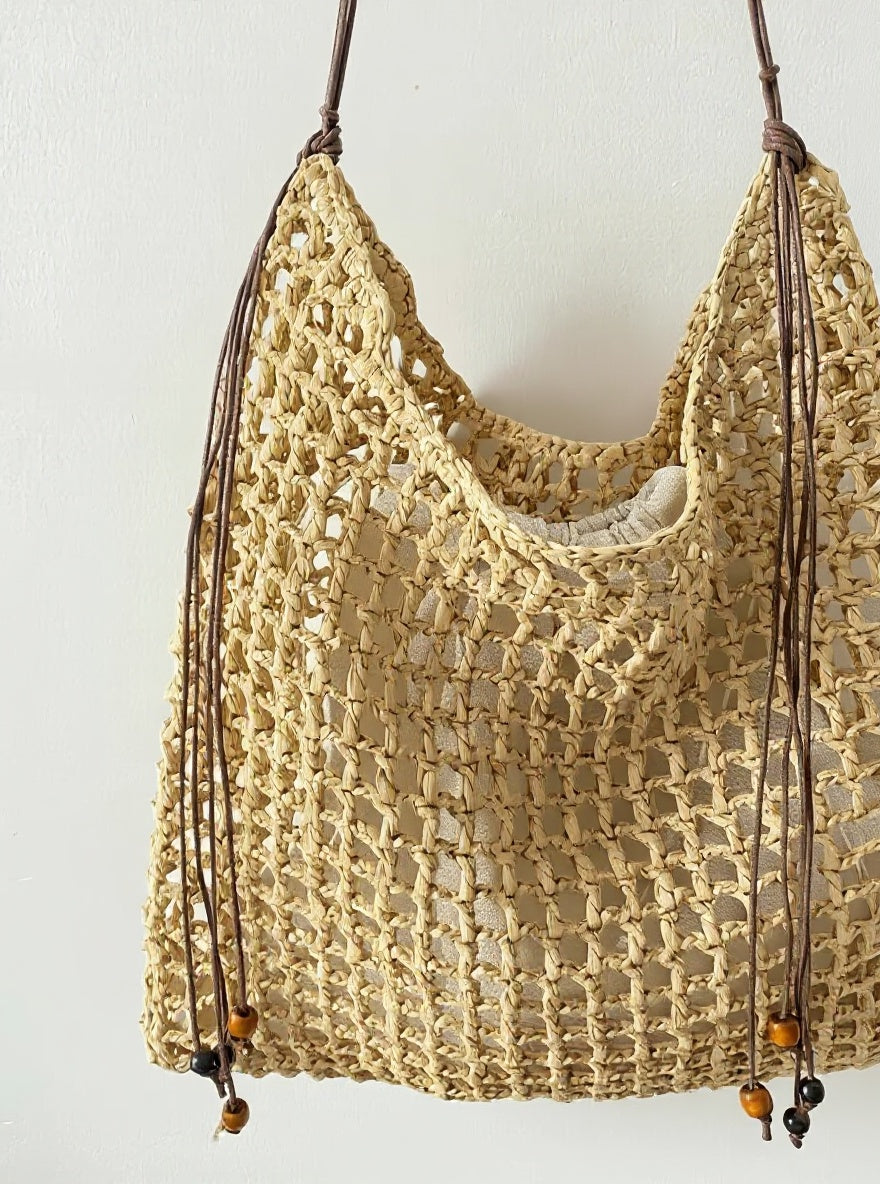 Wildfool Beaded Grass Tote in Black — three-quarter view, strap over shoulder