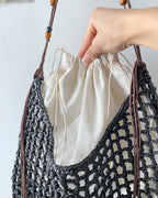 Wildfool Beaded Grass Tote in Black — three-quarter view, strap over shoulder