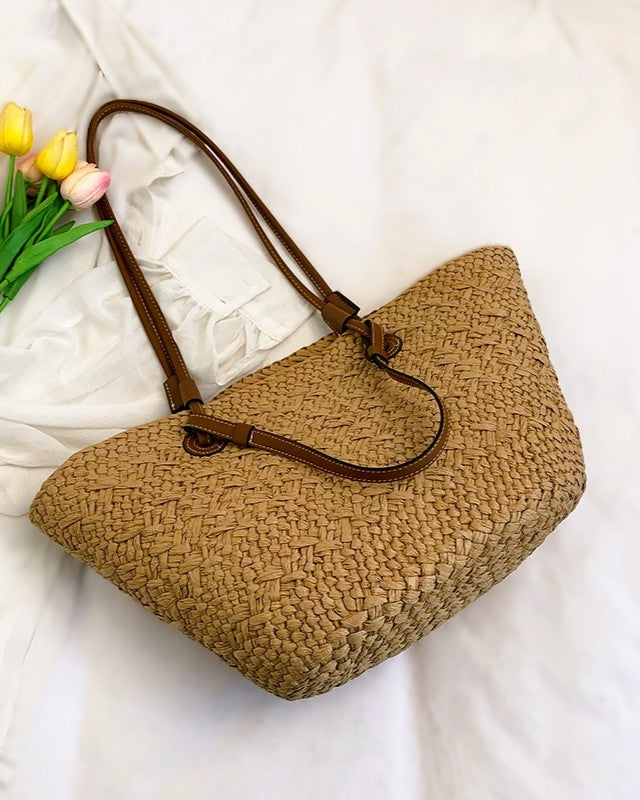 Cream basket tote styled with linen shirt — lifestyle flat lay with produce and novel
