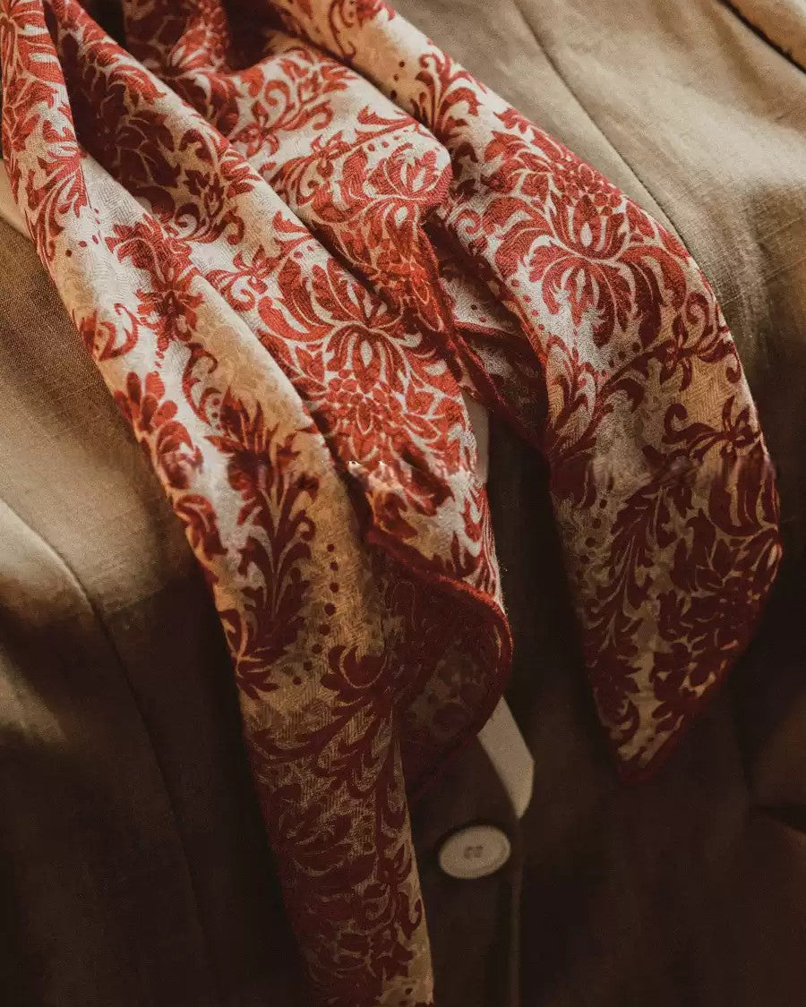Detail of curled vine and unfurled leaf baroque pattern on silk wool blend surface