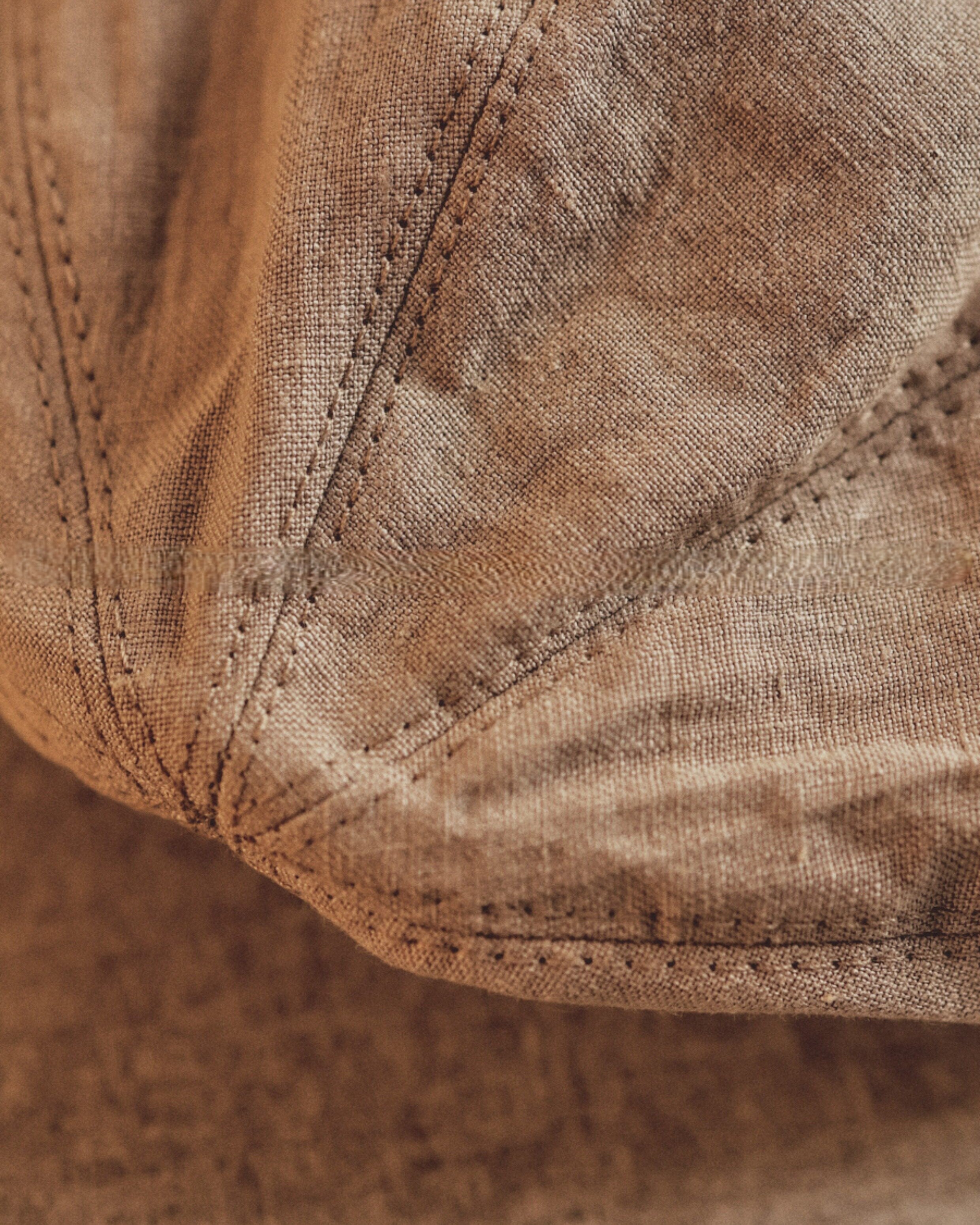 Wildfool Washed Linen Docker Cap in White — close-up of pre-washed linen texture