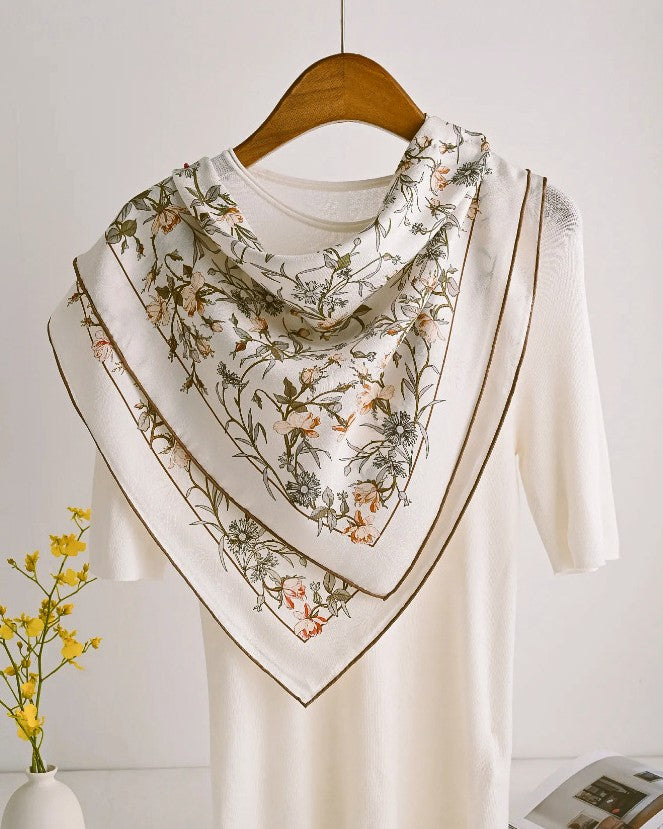 Detail of coral pink roses and pale apricot wildflowers with brown vine weaving