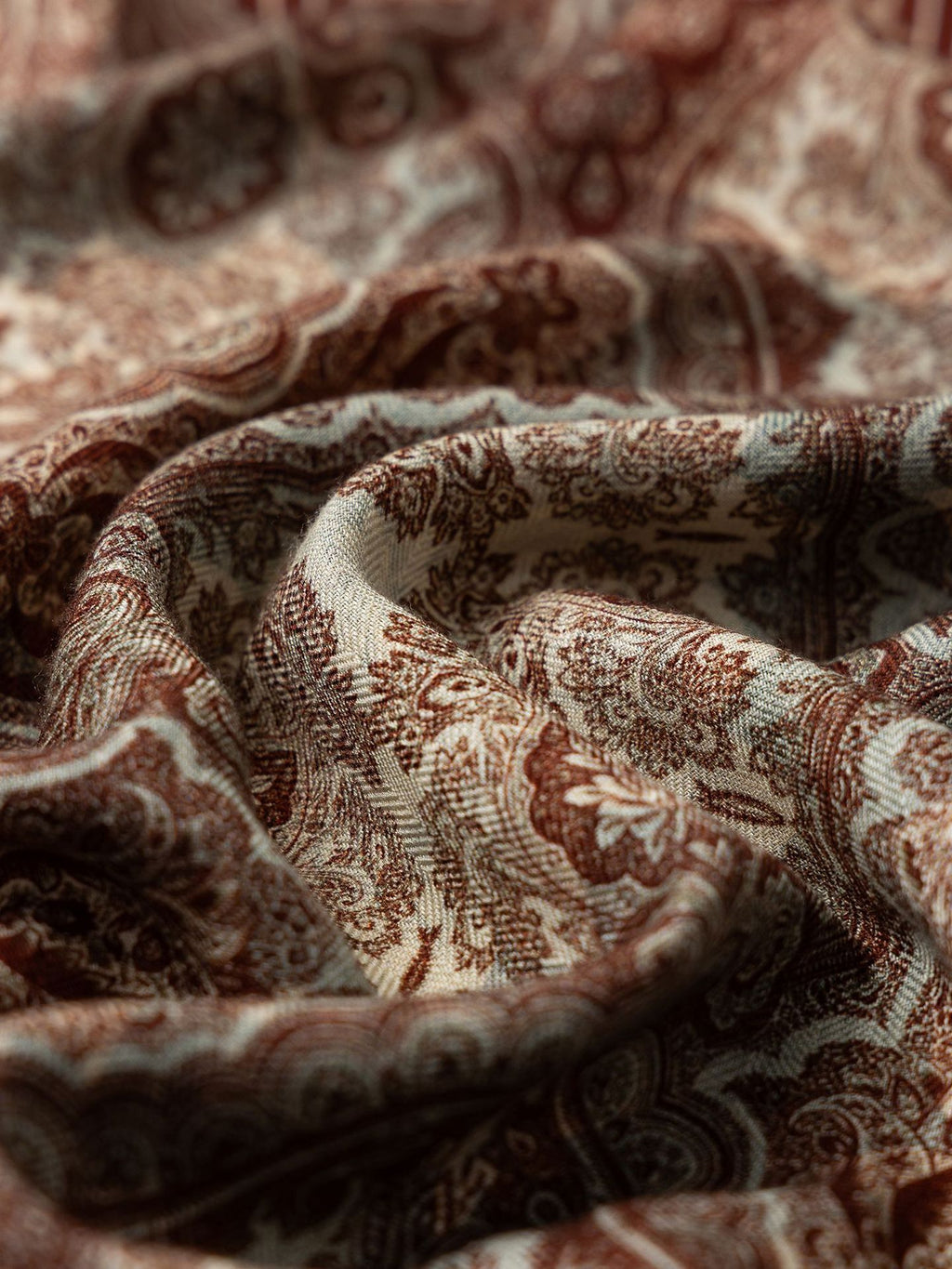 Wildfool Silk Road scarf draped showing brick-red paisley and ink-green peony edge visible