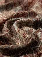 Wildfool Silk Road scarf draped showing brick-red paisley and ink-green peony edge visible