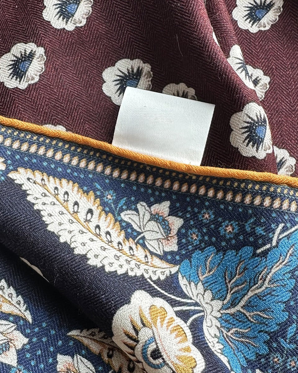Detail of gold vine border and piping on deep navy side of Wildfool reversible scarf
