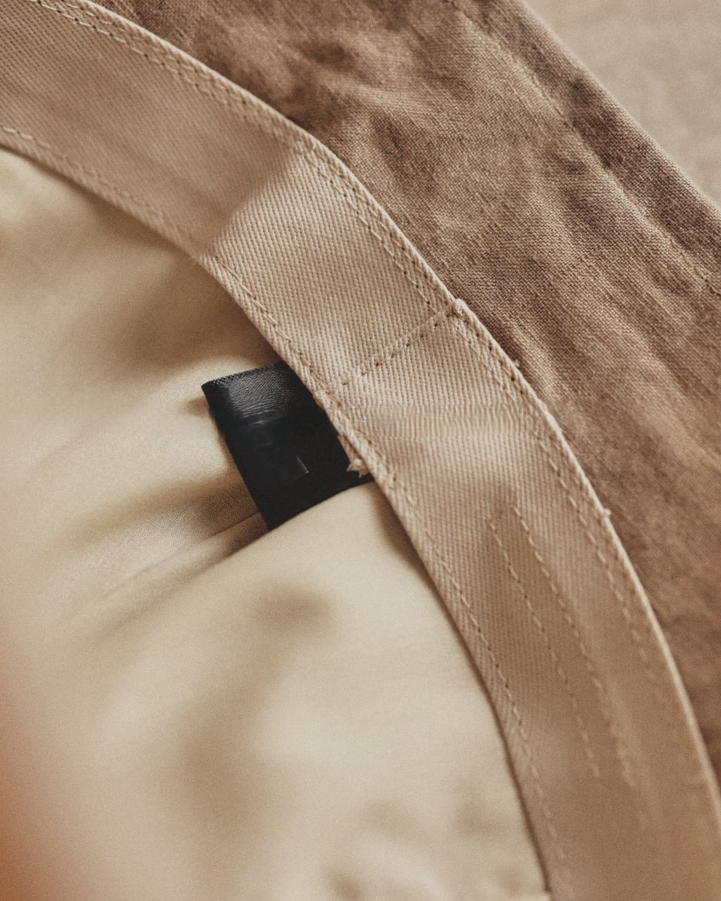 Wildfool Washed Linen Docker Cap in Black — three-quarter view showing minimal brim