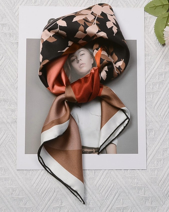 Detail of pink-brown leaf silhouettes within black geometric blocks, and hand-rolled edge finishing