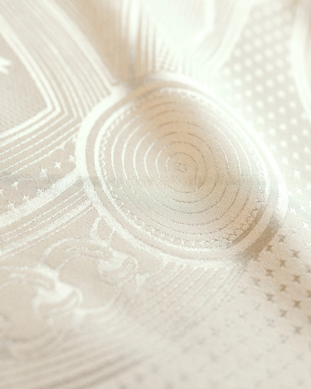 Wildfool ivory silk scarf folded showing jacquard pattern catching light at angle