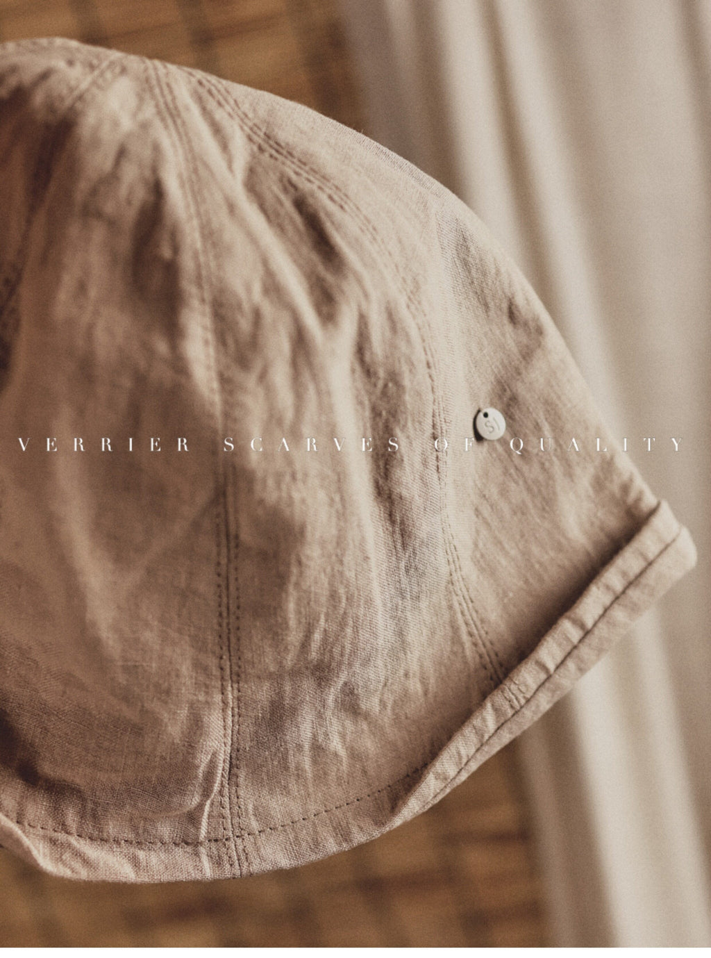 Wildfool Washed Linen Docker Cap in White — flat lay on natural linen surface