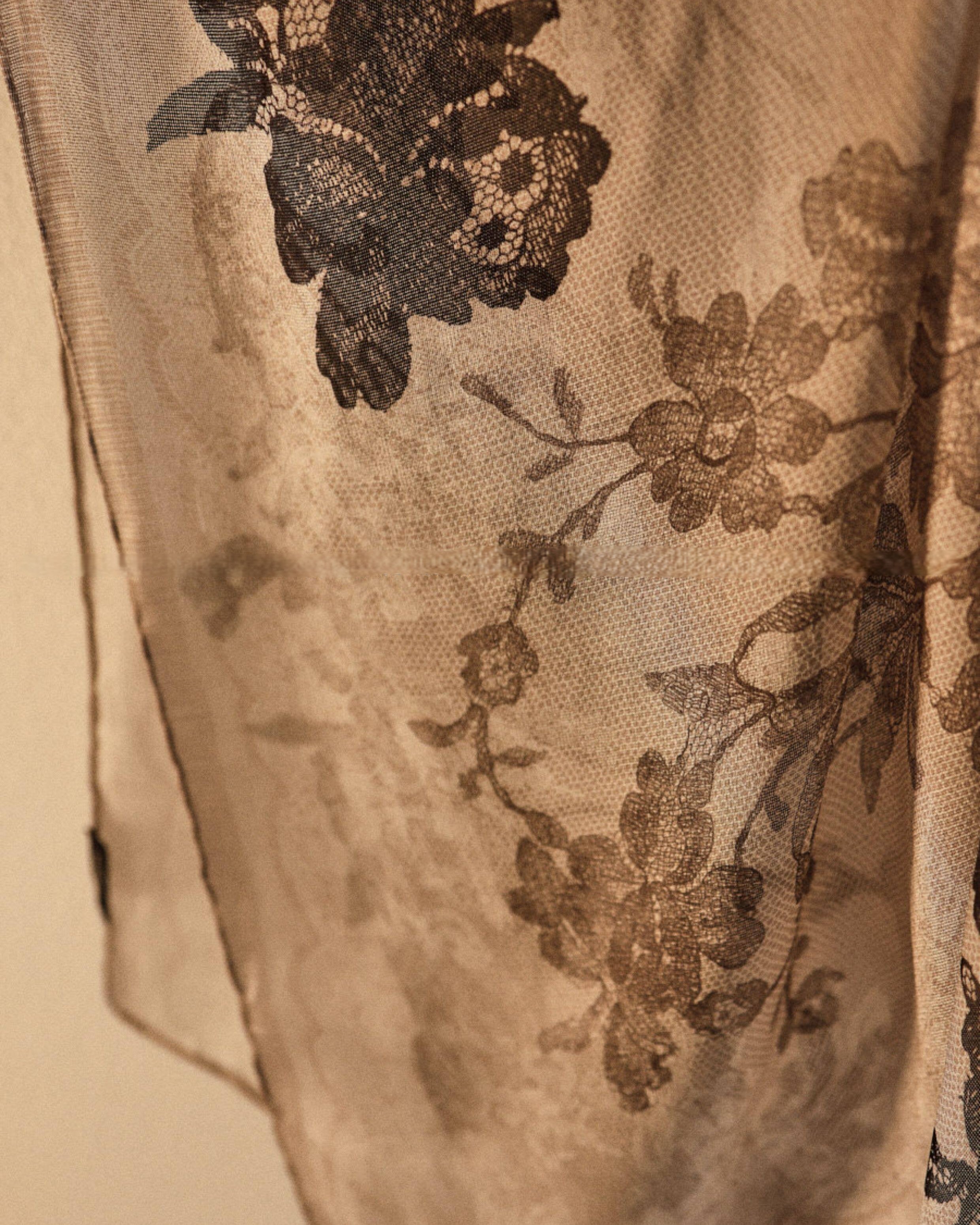 Wildfool silk chiffon scarf with lace floral print — held to light showing transparency