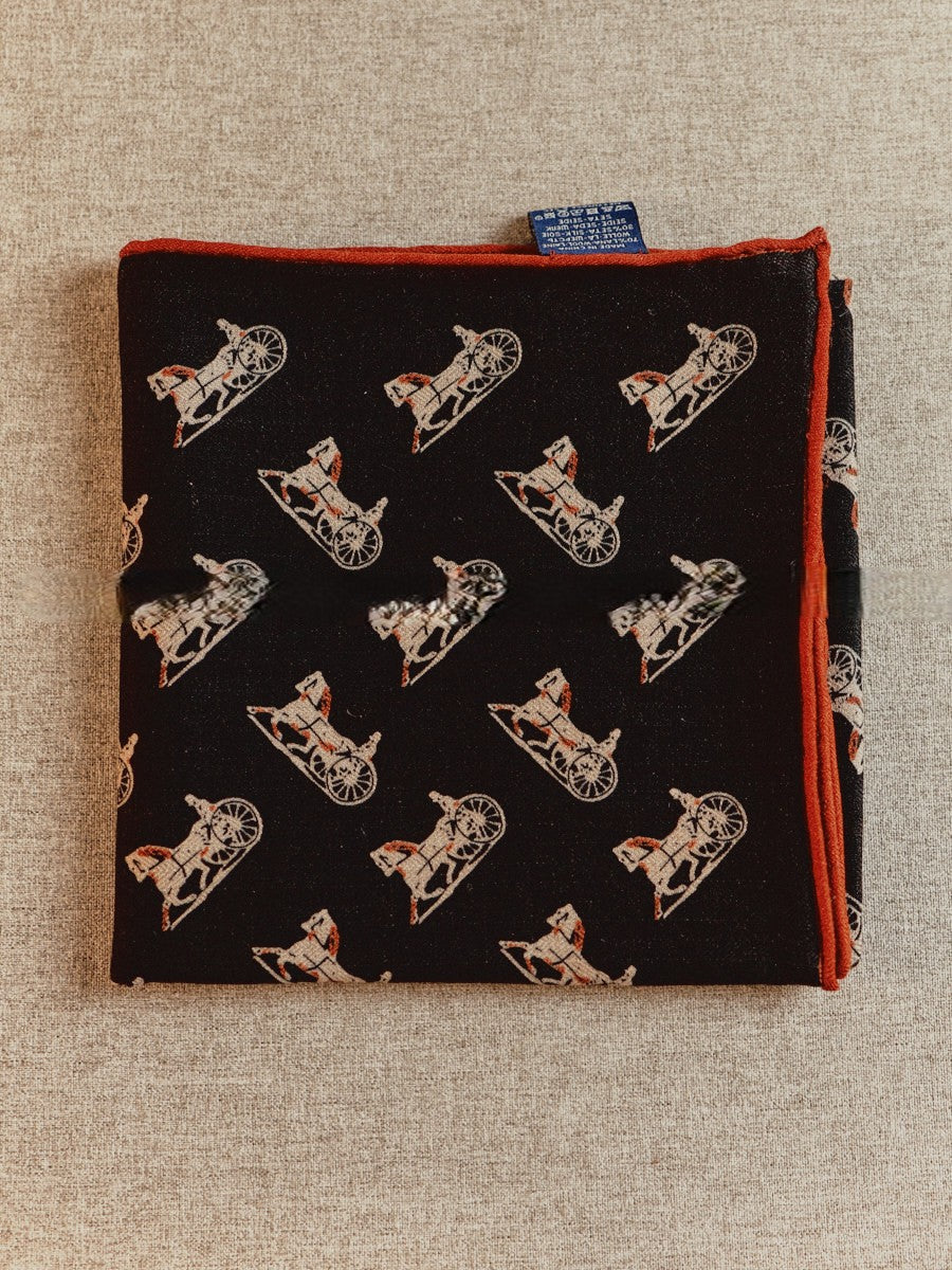Reverse brick-red side of Wildfool silk wool carriage scarf showing cream line-drawn carriages
