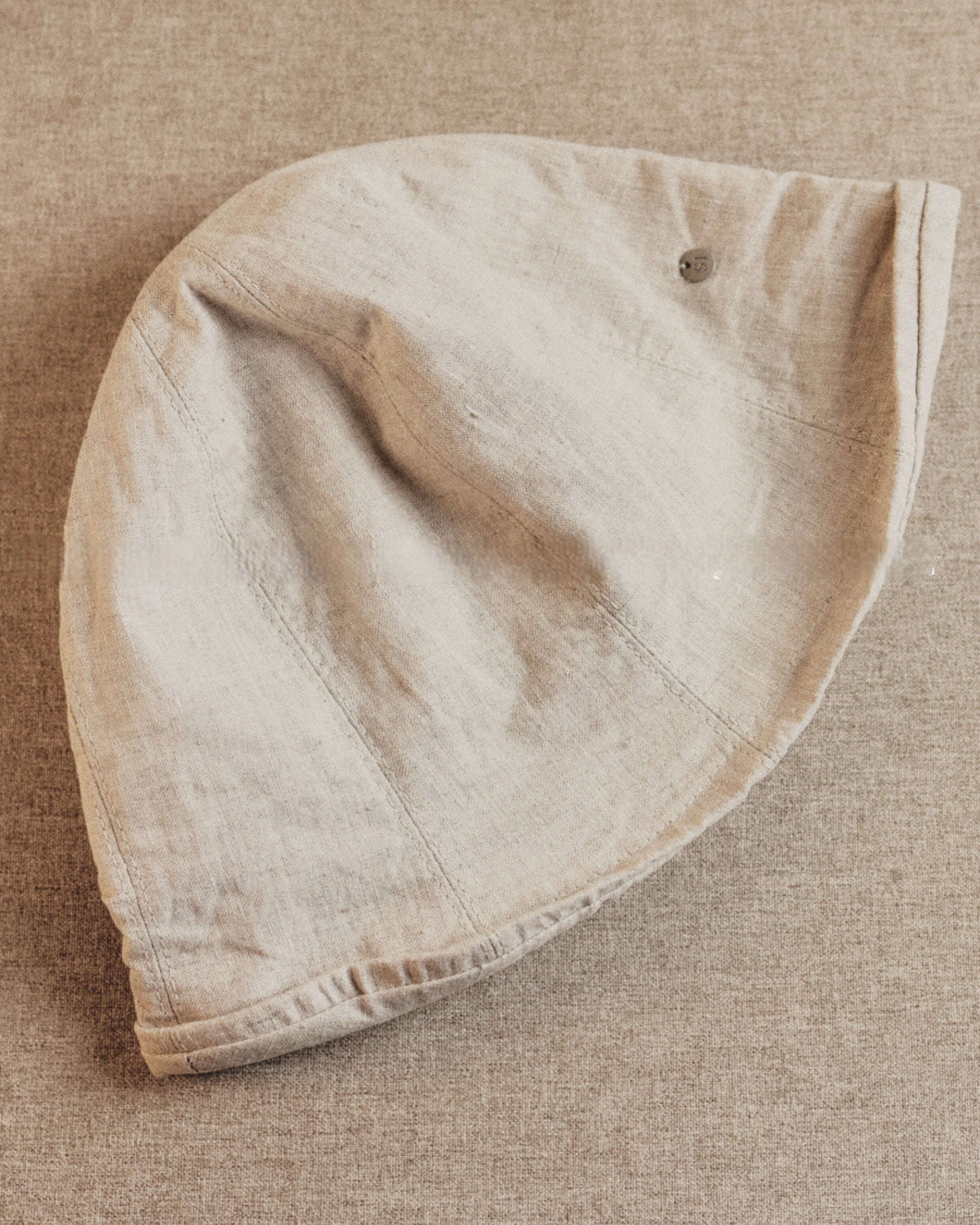 Wildfool Washed Linen Docker Cap in Black — three-quarter view showing minimal brim