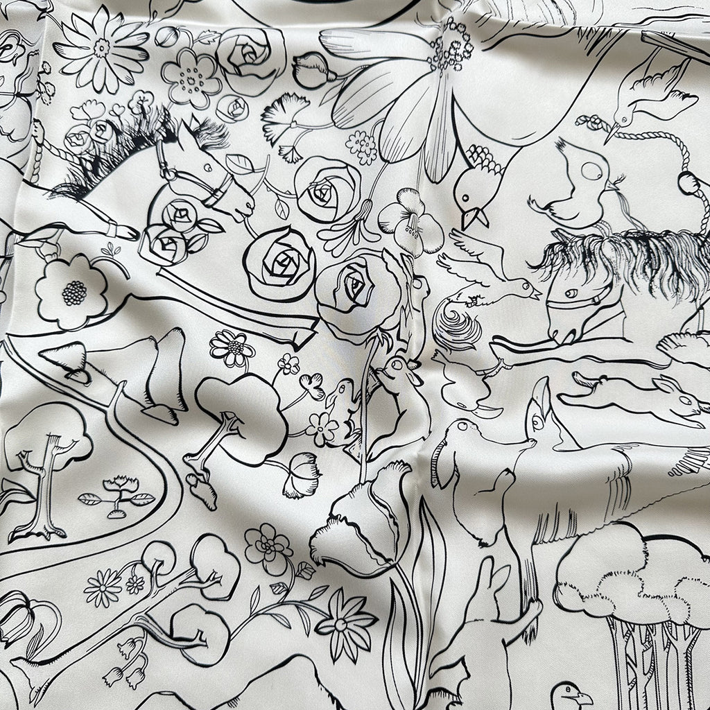 Wildfool mulberry silk square scarf in black and white rabbit motif — draped loosely over one shoulder