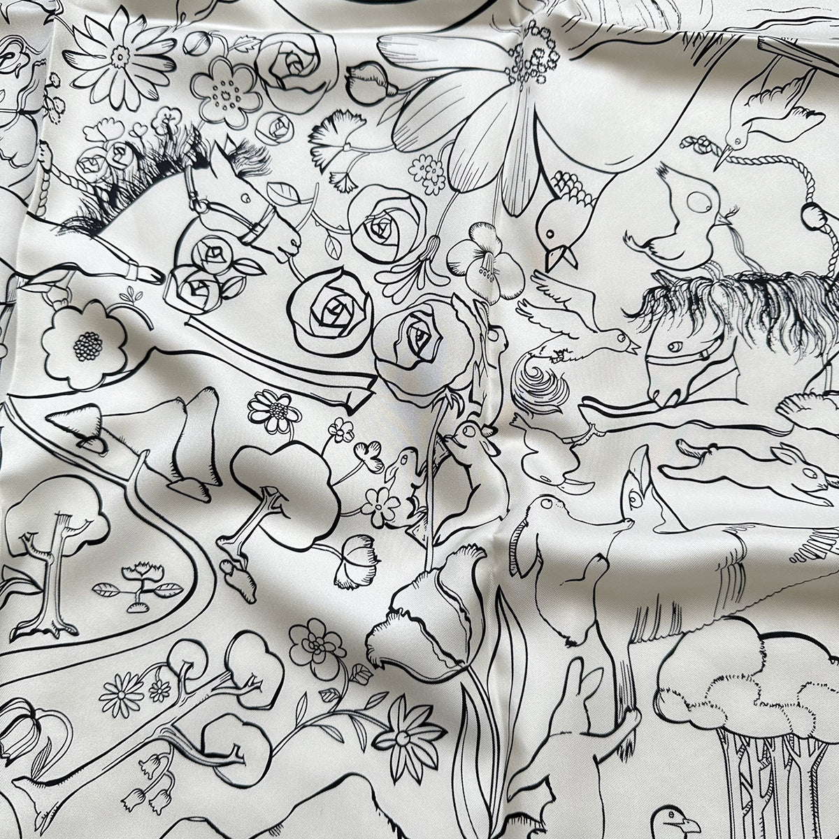 Wildfool mulberry silk square scarf in black and white rabbit motif — draped loosely over one shoulder