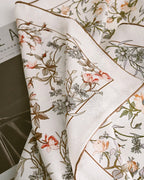 Cream silk scarf tied at neck showing movement and light through lace weave