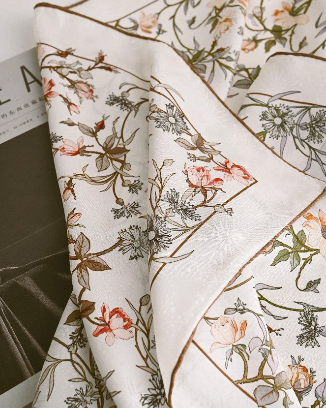 Cream silk scarf tied at neck showing movement and light through lace weave