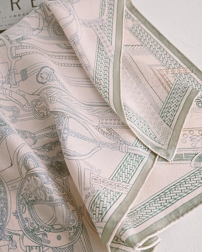Woman wearing pale pink-cream silk scarf showing how pattern reads as nearly solid from distance