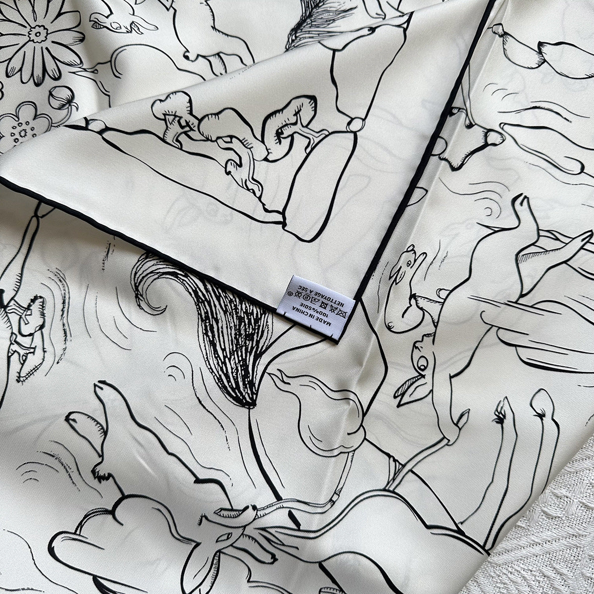 Close-up detail of hand-drawn rabbit illustrations on Wildfool 18mm mulberry silk scarf