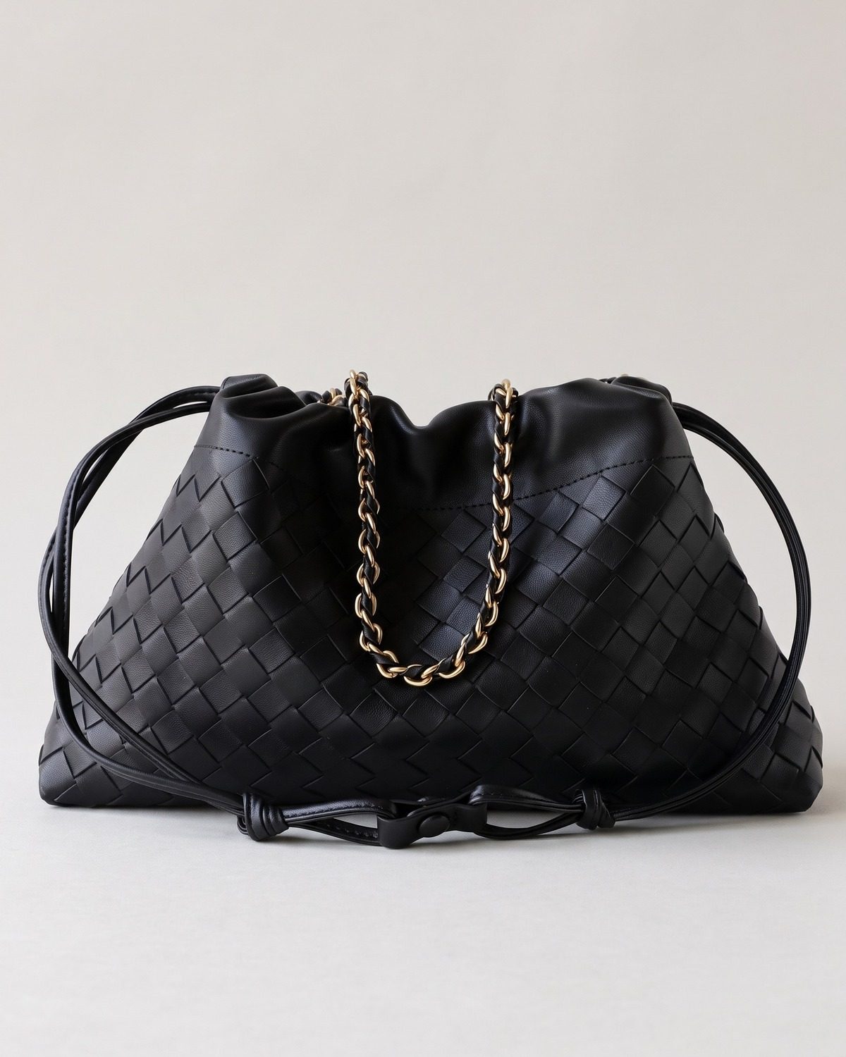 Wildfool The Assisi Chain Pouch in Black, black woven lambskin drawstring bag with threaded gold-tone chain