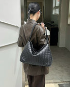 Wildfool The Treviso Woven Hobo in Black, worn on the shoulder