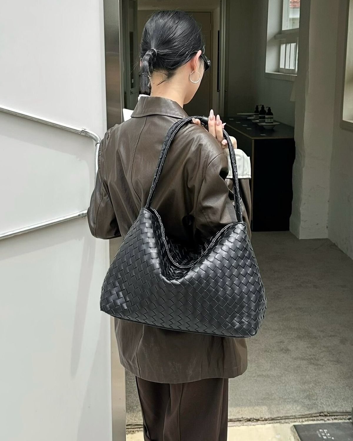 Wildfool The Treviso Woven Hobo in Black, worn on the shoulder