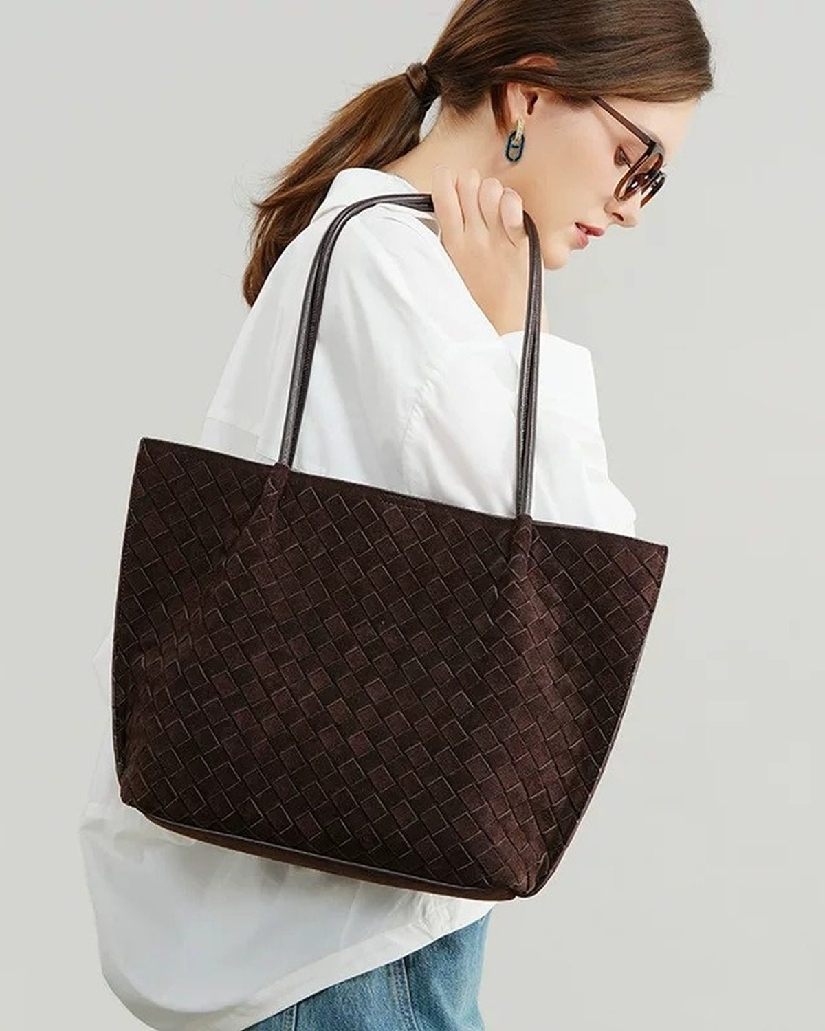Wildfool The Perugia Woven Tote in Chocolate, worn on the shoulder