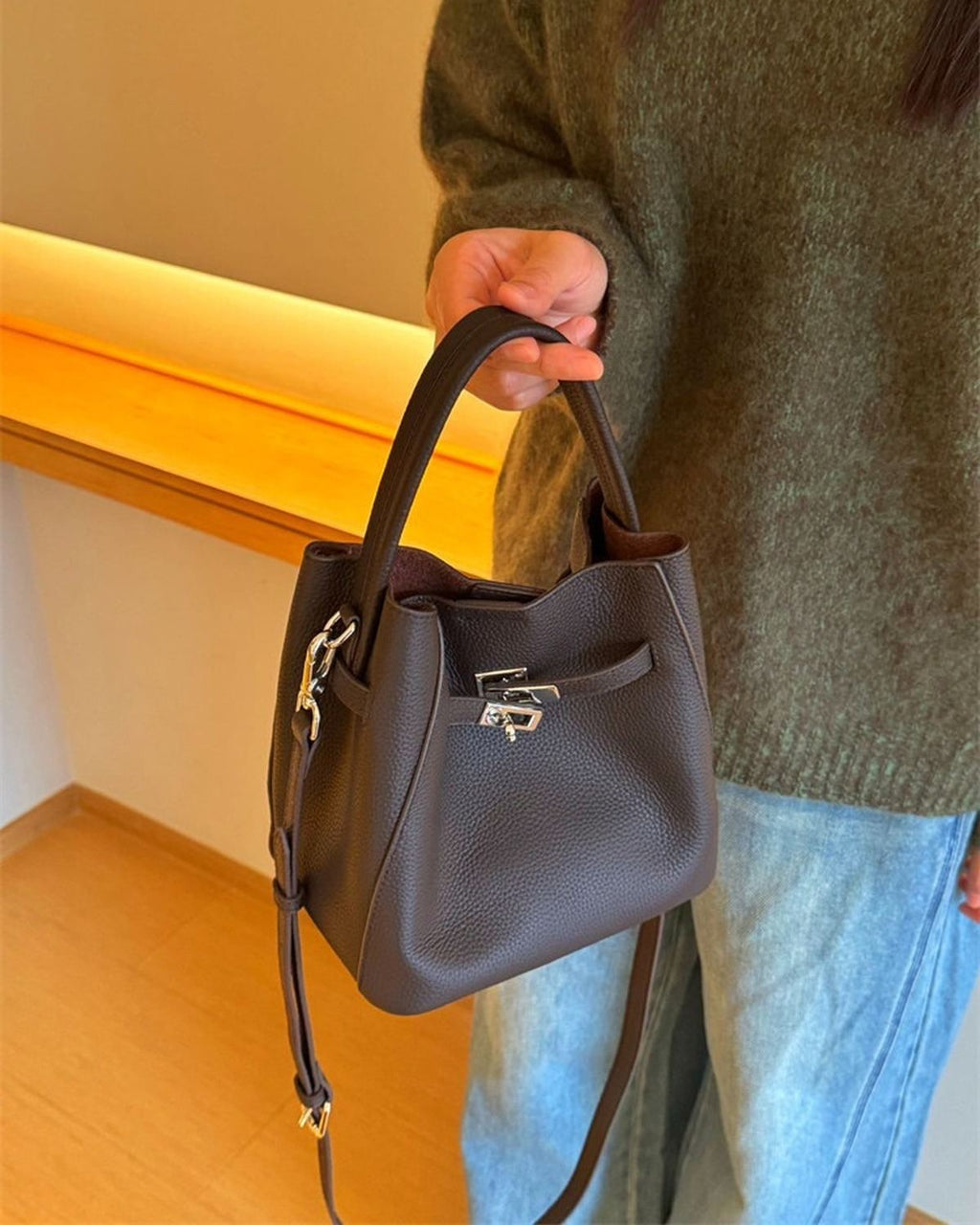 Wildfool The Orvieto Mini Bucket in Espresso, carried by hand, close up