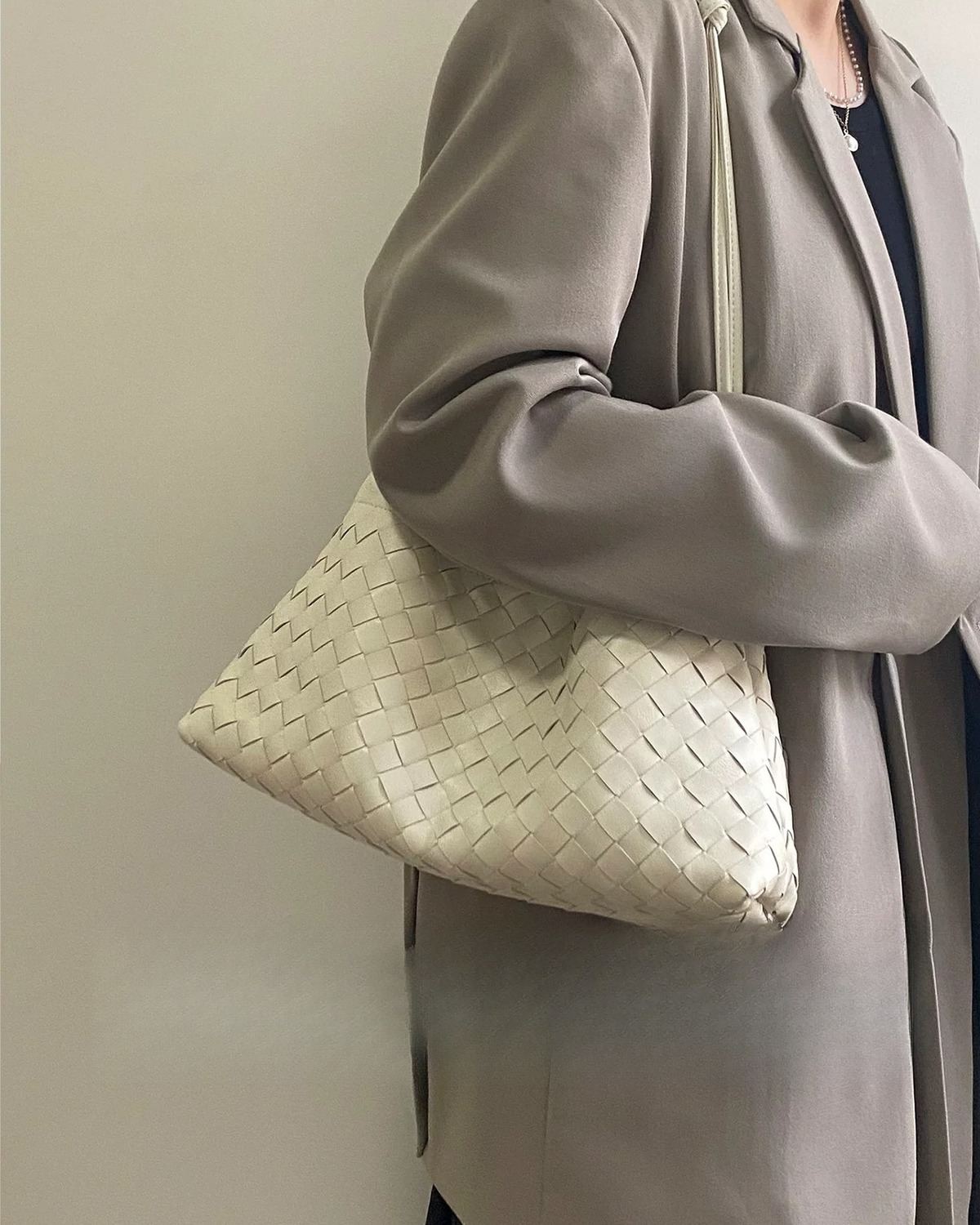 Wildfool The Assisi Chain Pouch in Ivory, worn on the shoulder