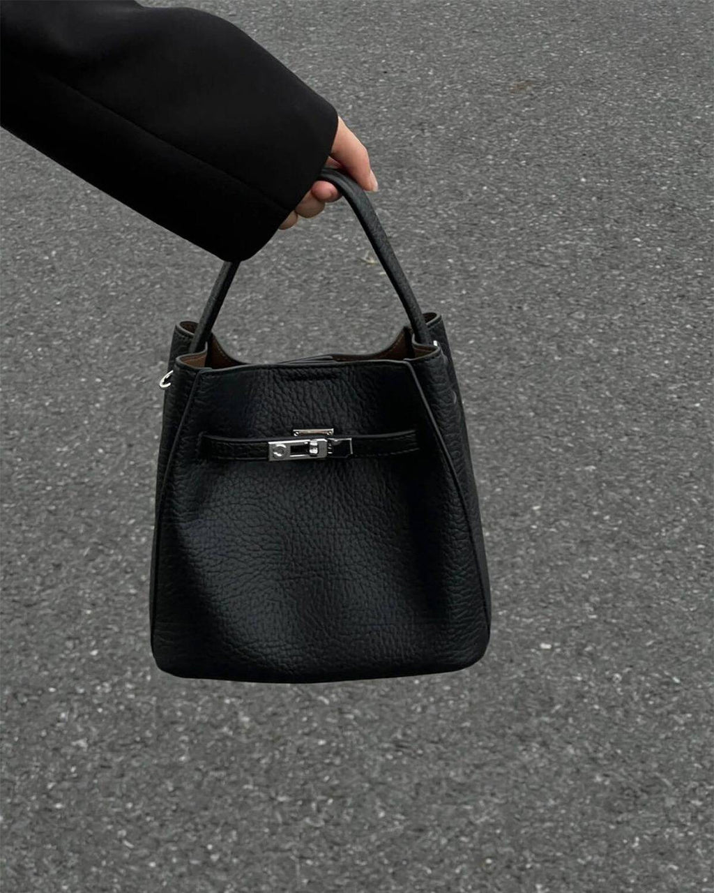 Wildfool The Orvieto Mini Bucket in Black, carried by hand, close up
