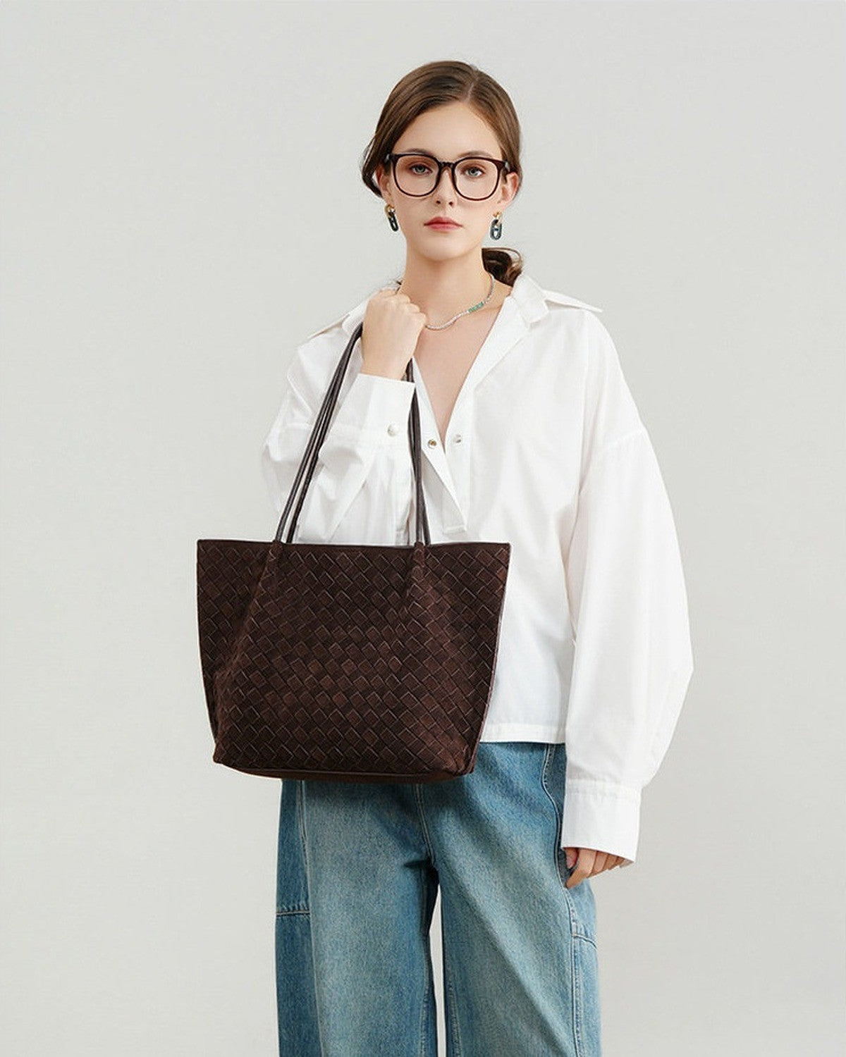 Wildfool The Perugia Woven Tote in Chocolate, carried by hand