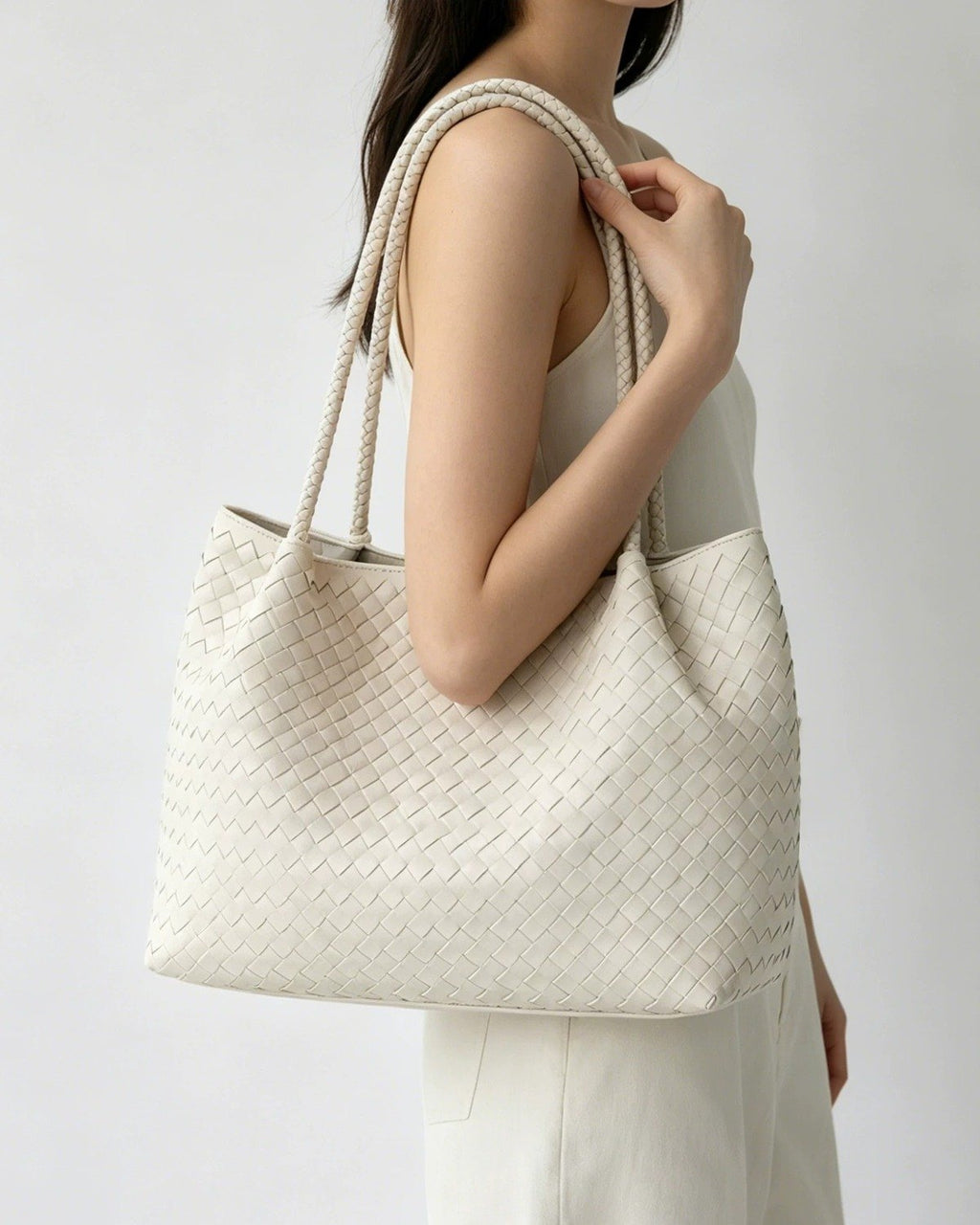 Wildfool The Vicenza Woven Tote in Ivory, worn on the shoulder