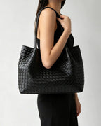 Wildfool The Vicenza Woven Tote in Black, worn on the shoulder