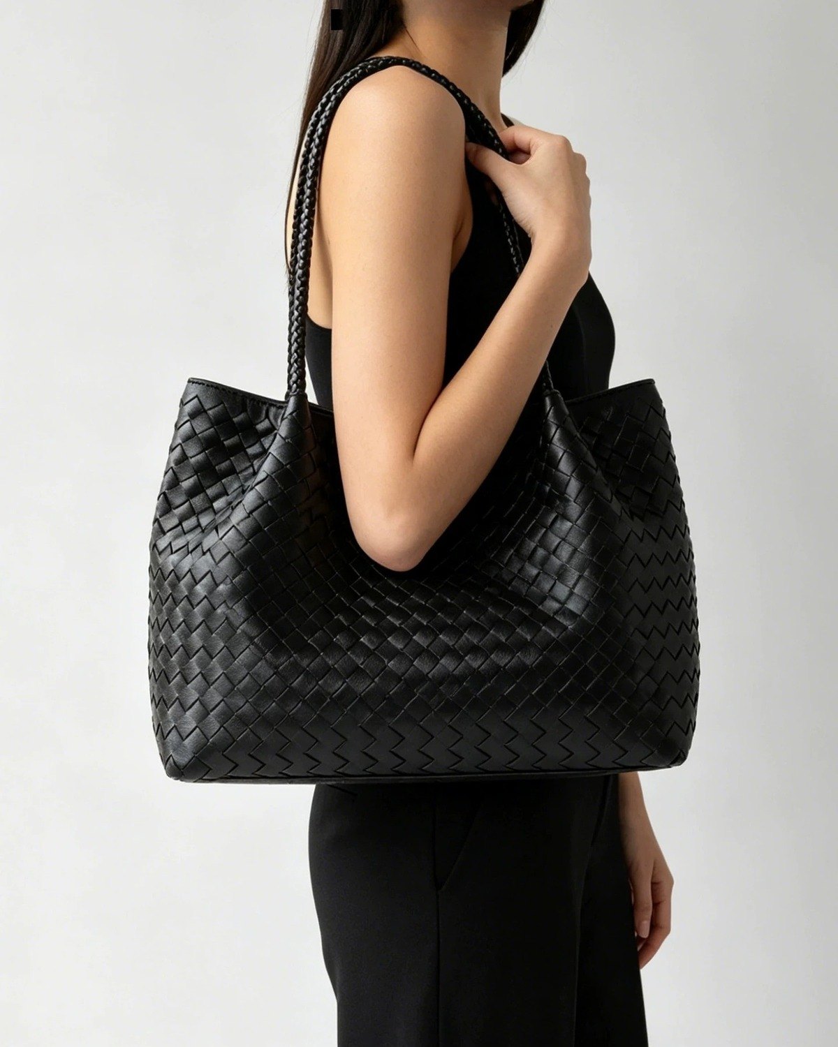 Wildfool The Vicenza Woven Tote in Black, worn on the shoulder
