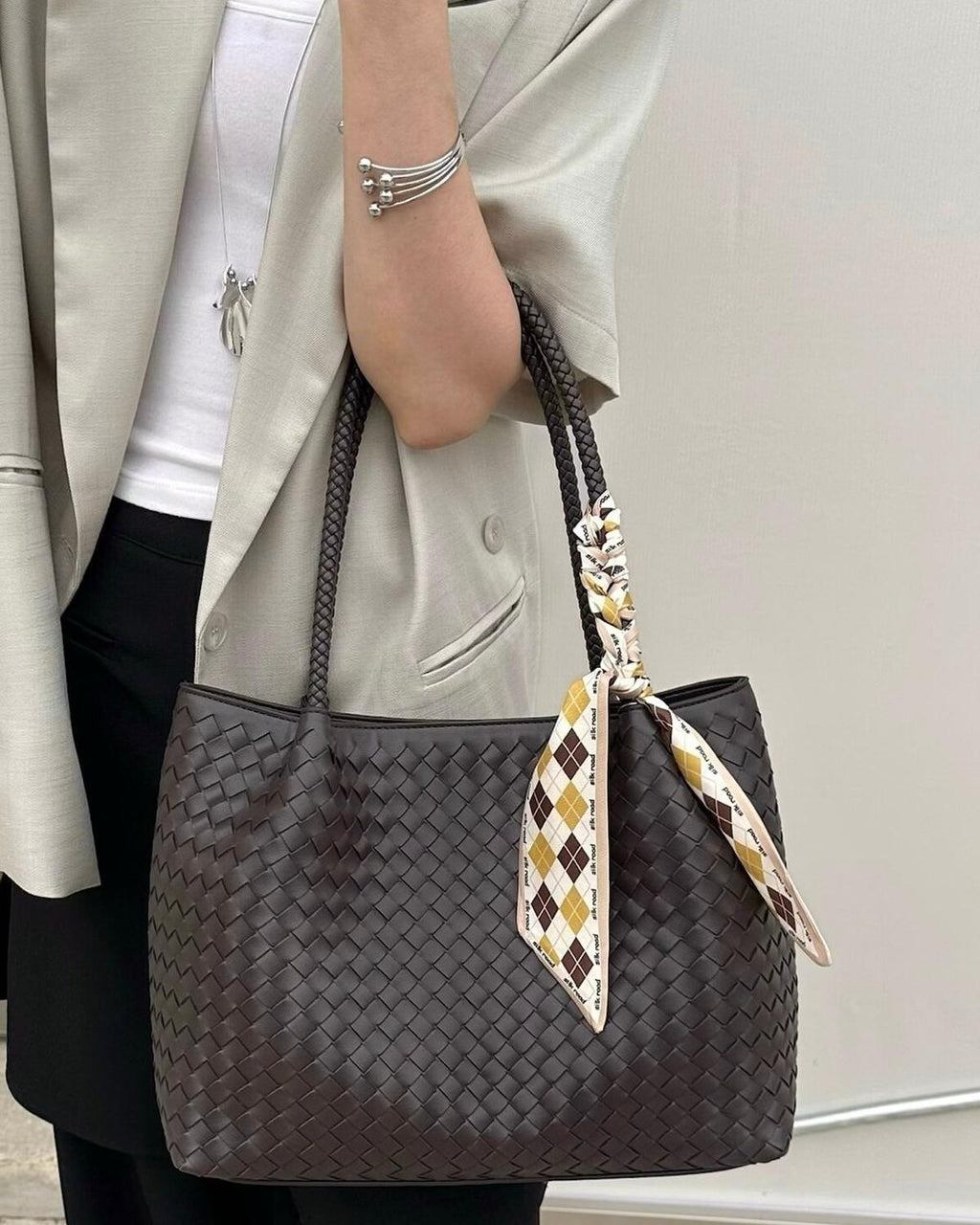 Wildfool The Vicenza Woven Tote in Espresso, carried by hand