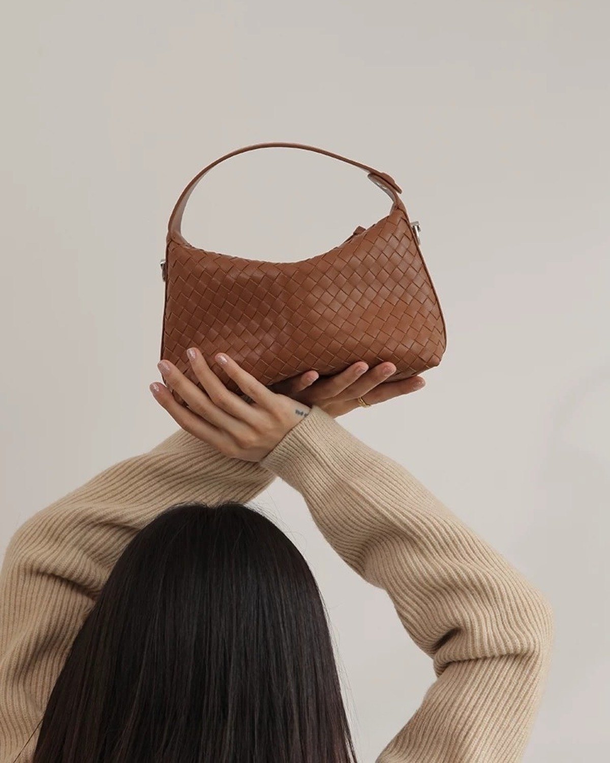 Wildfool The Parma Woven Mini Hobo in Caramel, carried by hand, close up