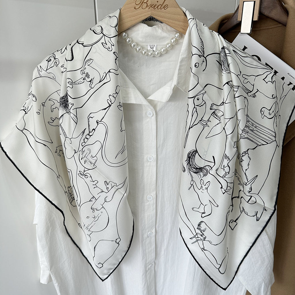 Line-drawn rabbit motif detail on white mulberry silk — Wildfool square scarf close-up