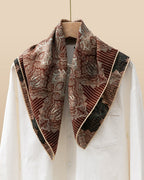 Close-up of Persian kashmir carving detail in brick-red on silk wool blend