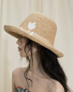 Wildfool Raffia Tulip Sun Hat in Honey — lifestyle outdoor setting, natural light