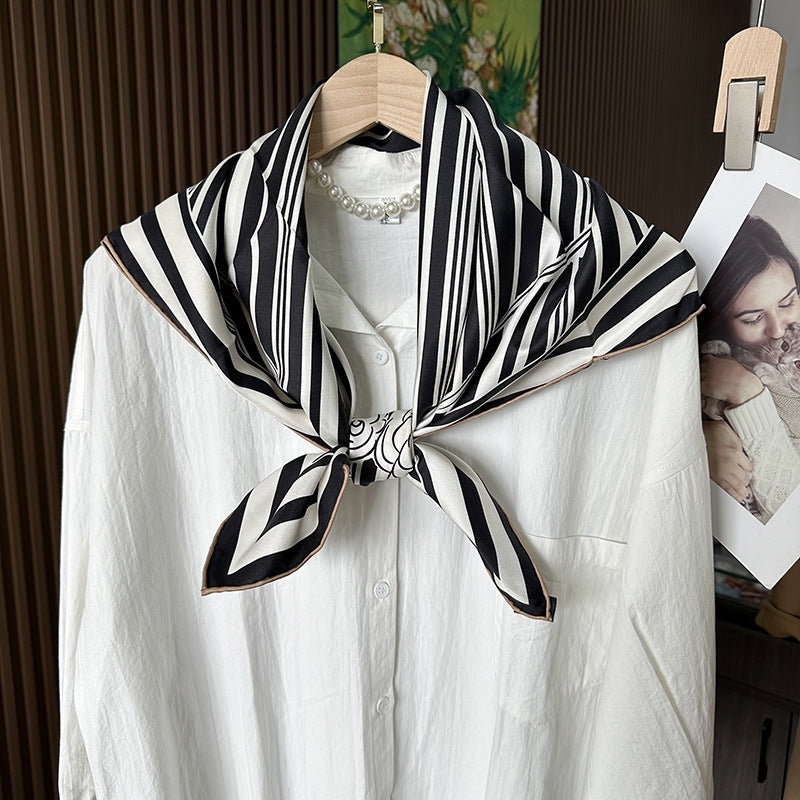 Wildfool silk scarf draped over shoulder showing diagonal stripe graphic from wearing distance