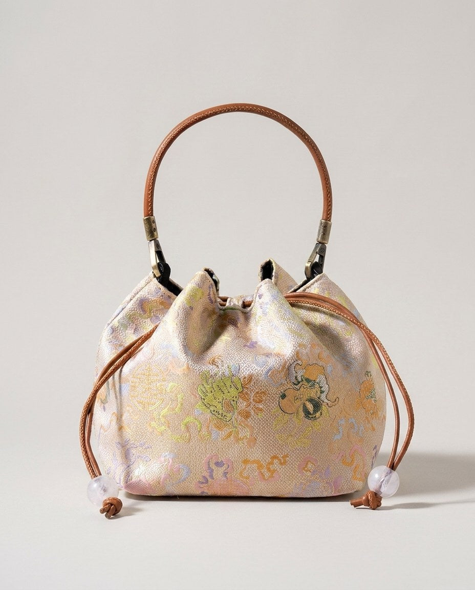 Wildfool The Brocade Bucket Bag in Celestial Bloom — pale gold silk brocade bucket bag