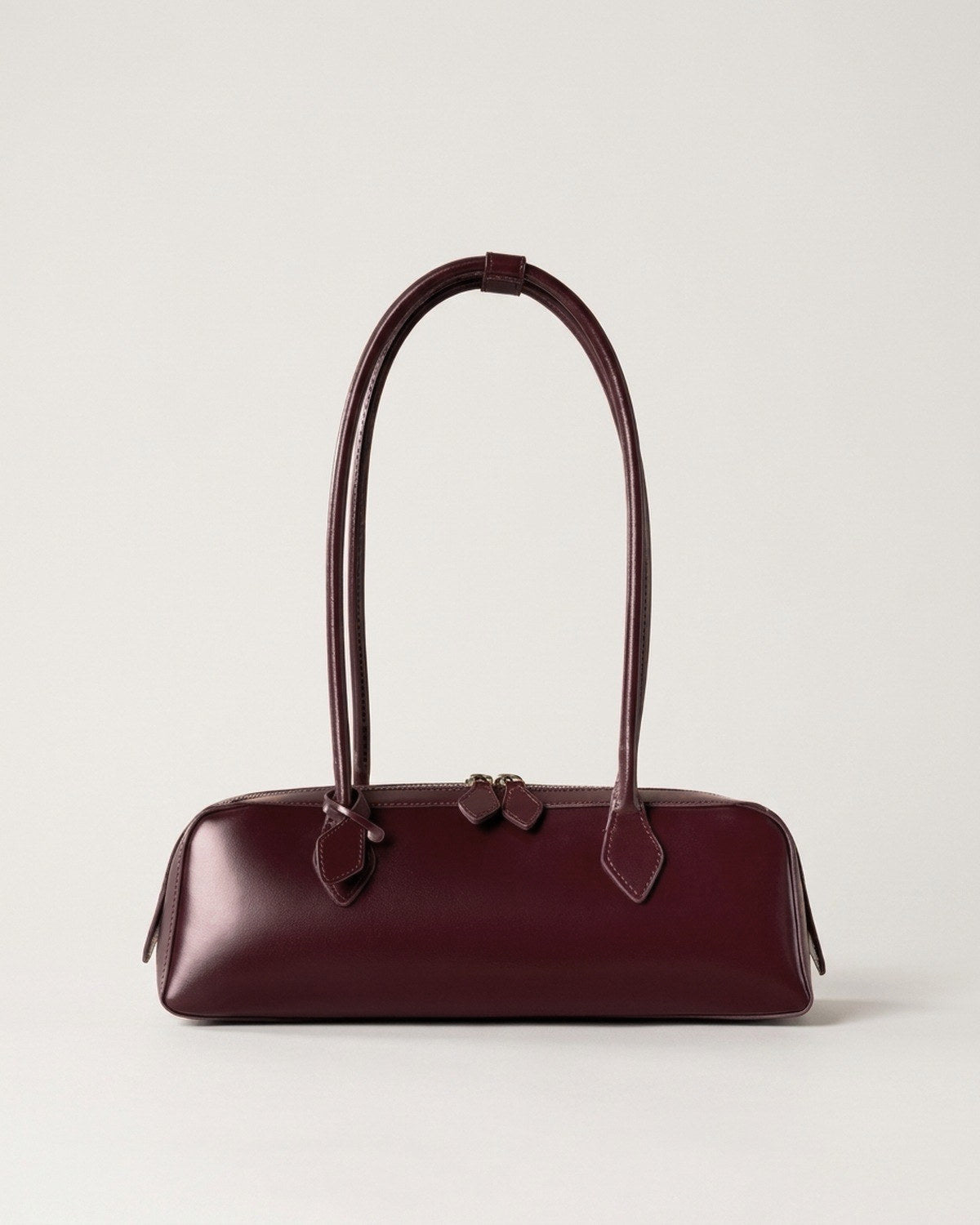 Wildfool The Cannes Baguette Bag in Burgundy — wine red leather baguette shoulder bag, leaf zip pulls
