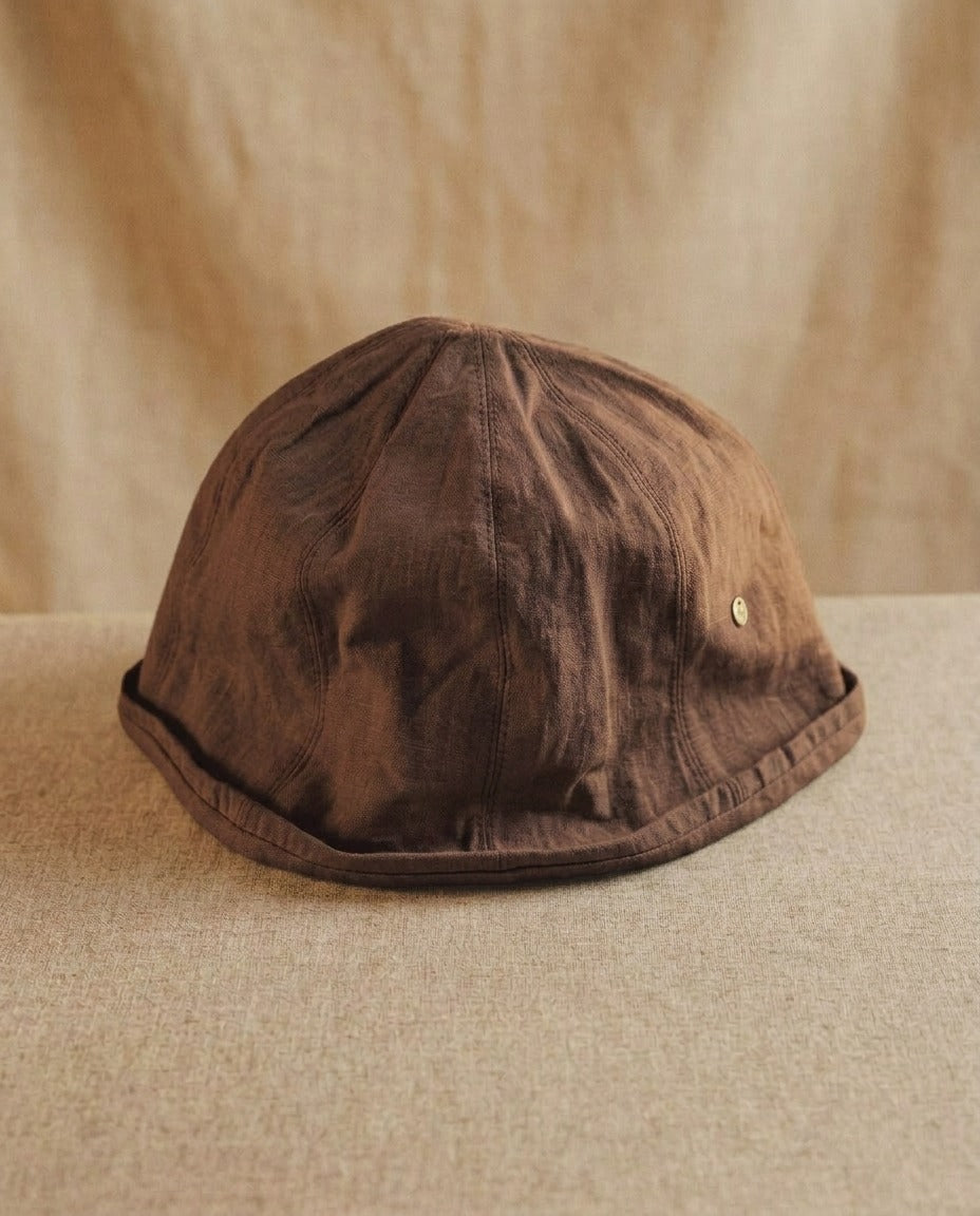 Wildfool Washed Linen Docker Cap in Espresso — side profile showing the six-panel crown and rolled brim