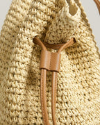 Wildfool Straw Bucket Bag in Cream �� close-up of woven straw texture and drawstring detail