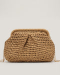 Camel straw shell bag detail showing weave texture and brass lock clasp